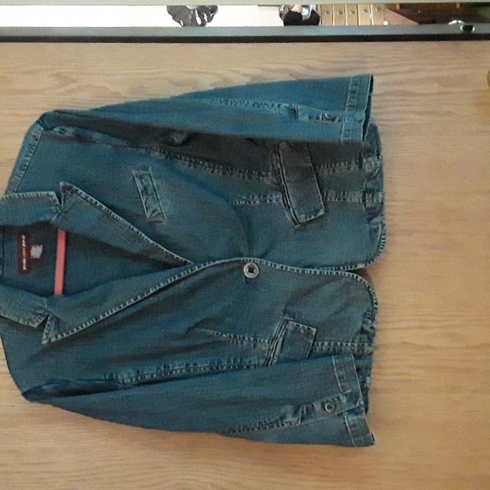 Jean Jacket Jones wear Jeans with black embroidery on the back.